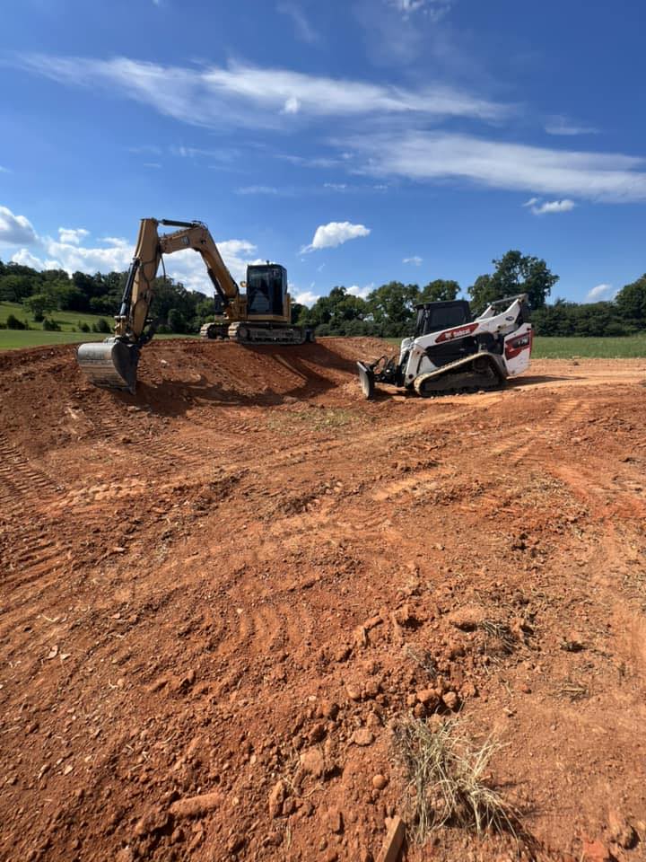 Excavator and compact track loader working on a prepared site