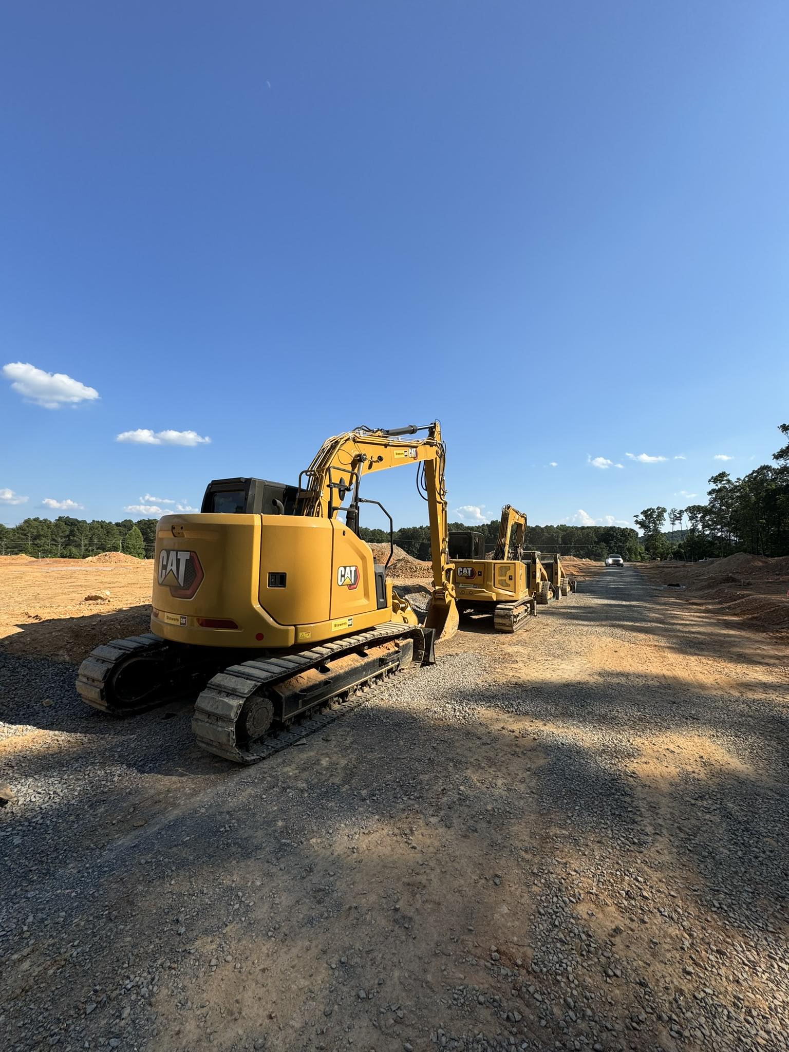 Excavators staged on a prepared construction site